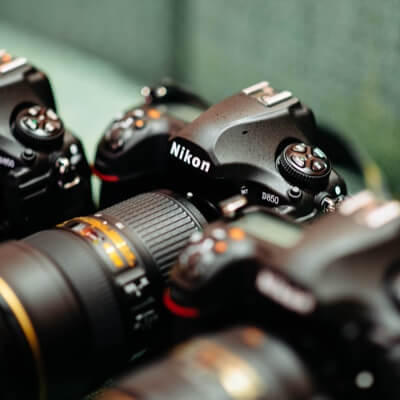 3 Nikon digital cameras lined up in a row